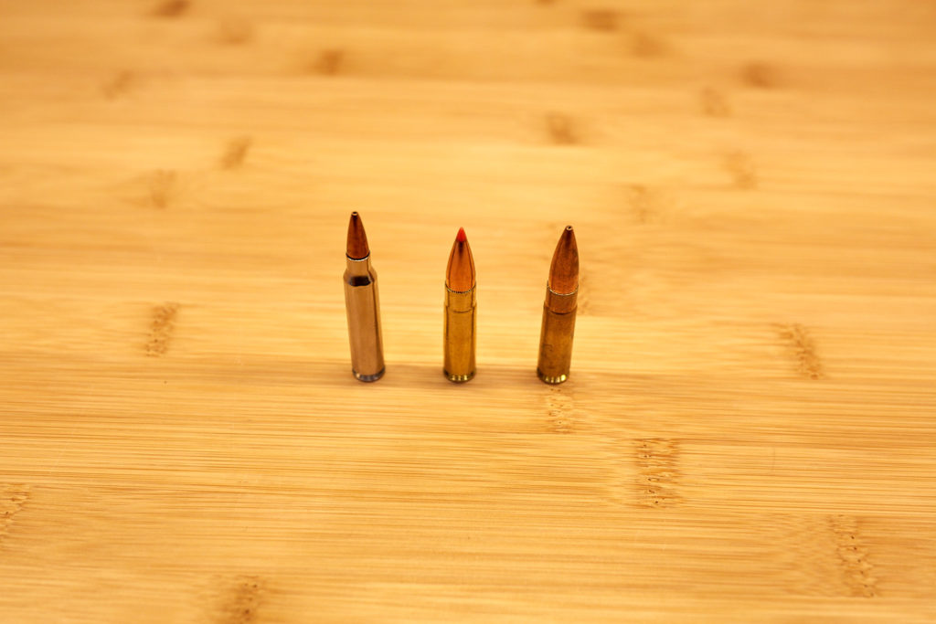 Image of 5.56 mm round, .300 blk supersonic round, and .300 blk subsonic round